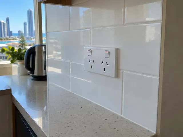 White double power point on tiled kitchen splashback beside a countertop and window view in Surfers Paradise